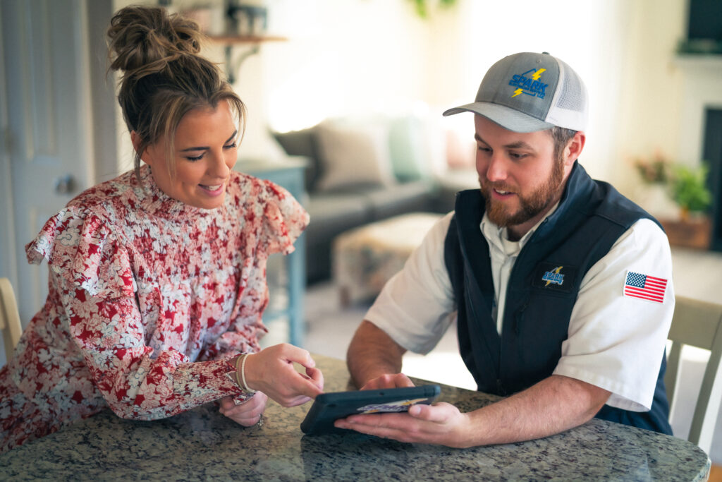 Commercial photography technician going over invoice with woman in house video production digital video advertising corporate video production in boston