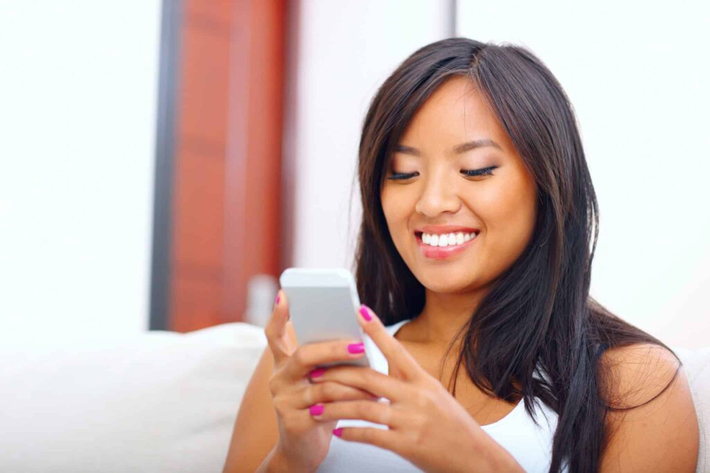 woman smiling at phone video production
