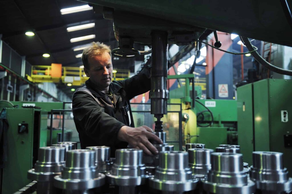 man working behind the scenes at a factory video production