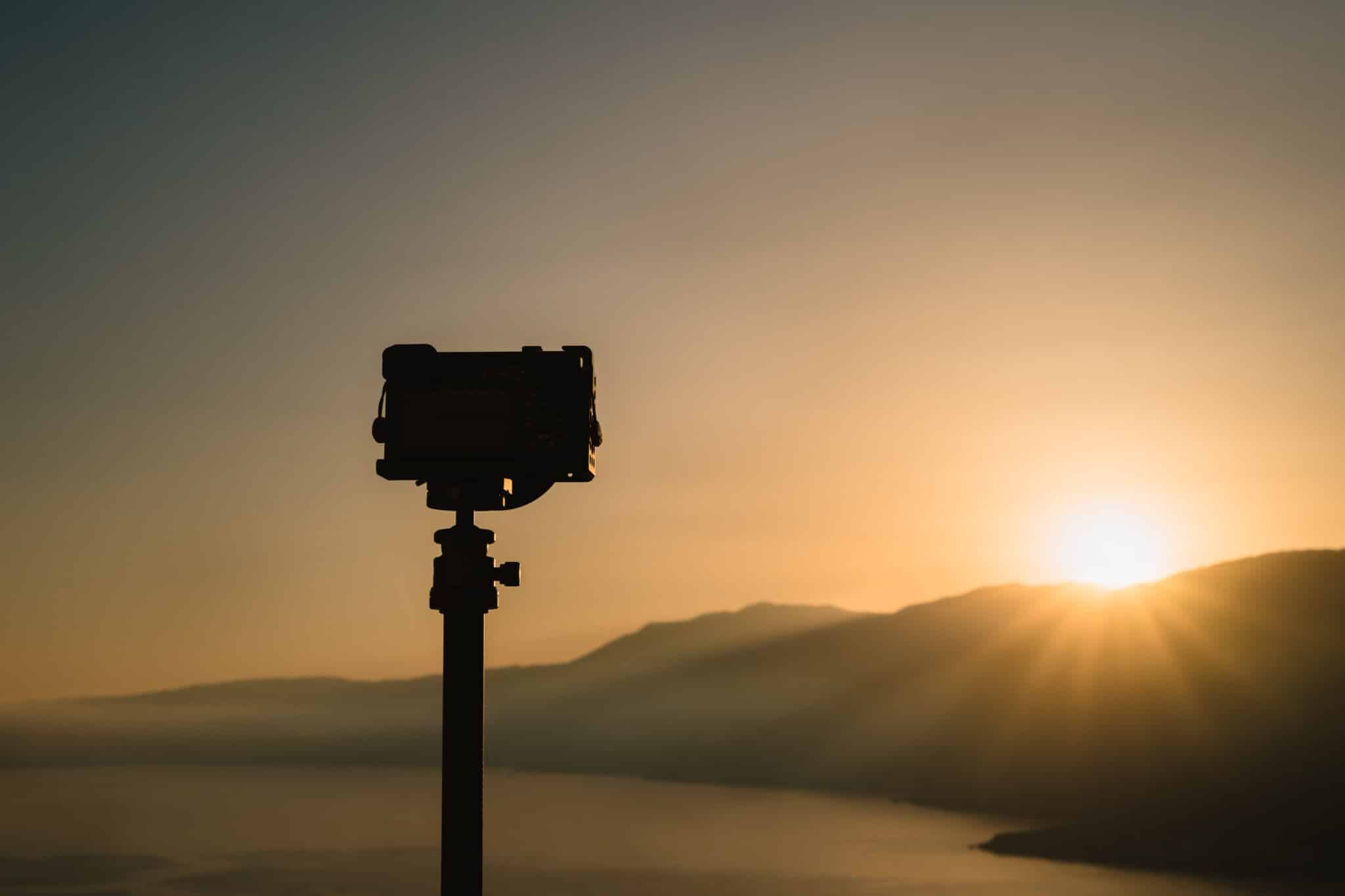 camera in shadow against a sunset video production