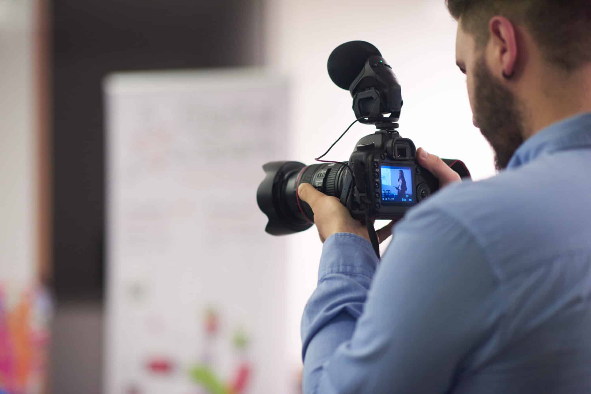 man holding a camera cinematic marketing