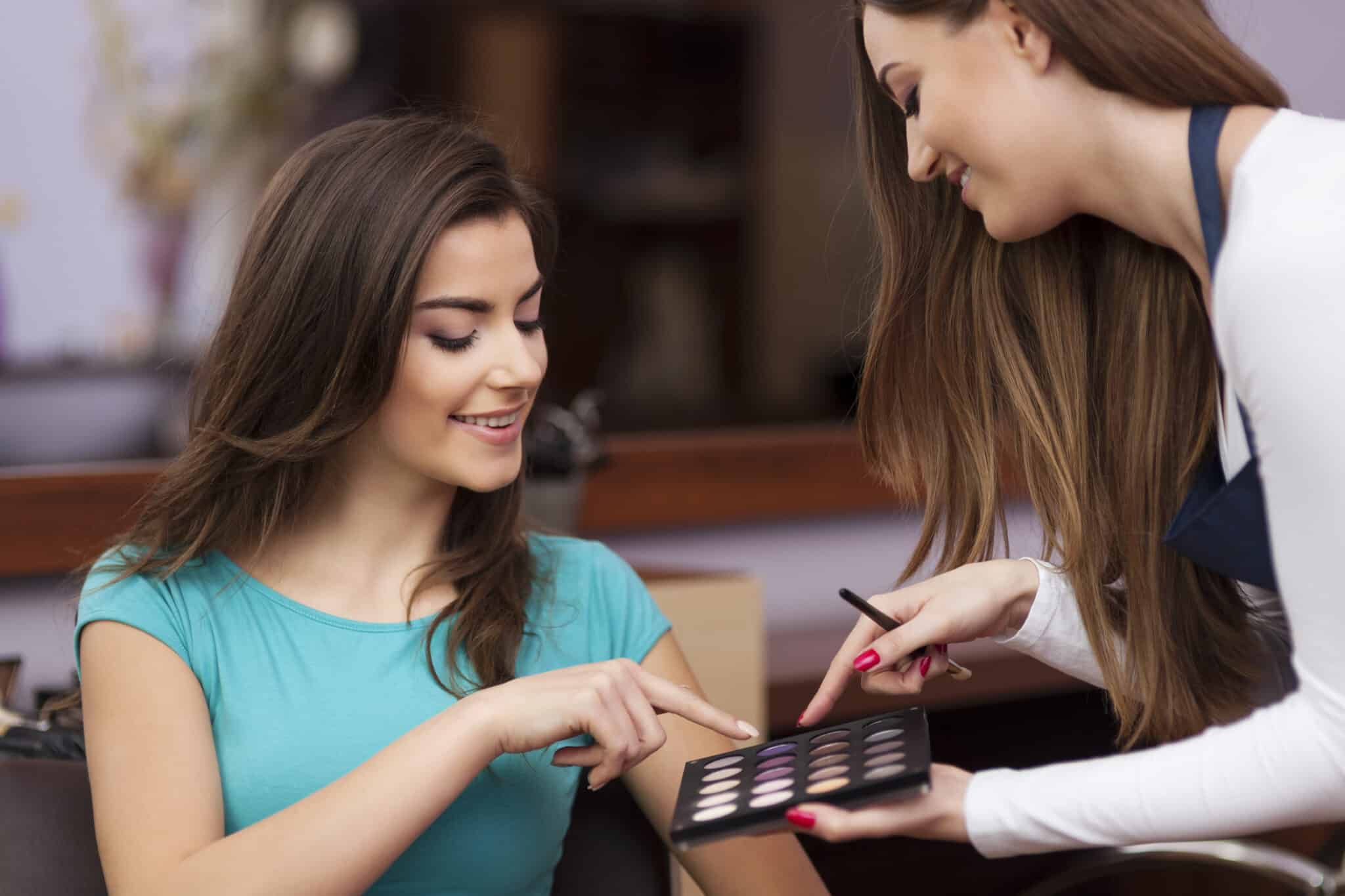 two women pointing at makeup video production