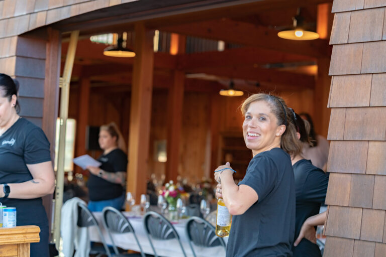 A bartender opens a bottle of wine, taken by NH Media Production