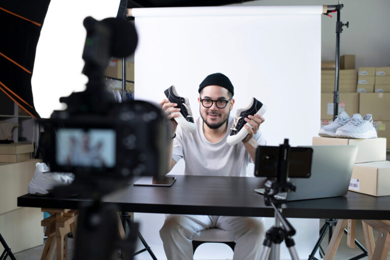 brand video production lifi media, Young attractive Asian man blogger or vlogger looking at camera reviewing product. Modern businessman using social media for marketing. Business online influencer on social media concept.