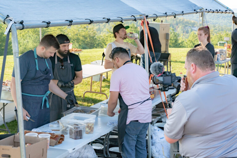 lifi media video production companies near me, videographer films an outdoor dining experience