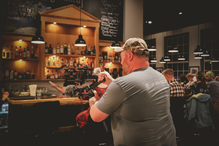 lifi media video production companies near me, videographer films an indoor dining experience