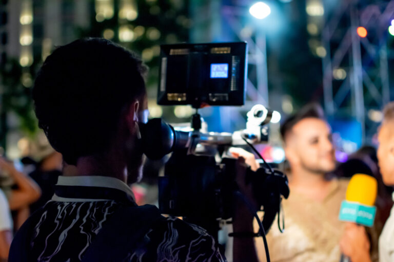 video marketing strategy lifi media production, videographer films two men conducting interview for television