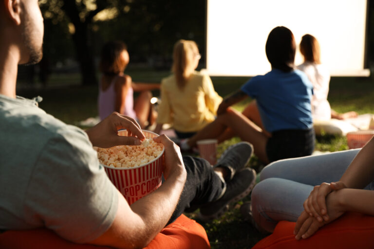 lifi media production documentary filmmaking, an audience sits in front of a screen waiting for a documentary to show