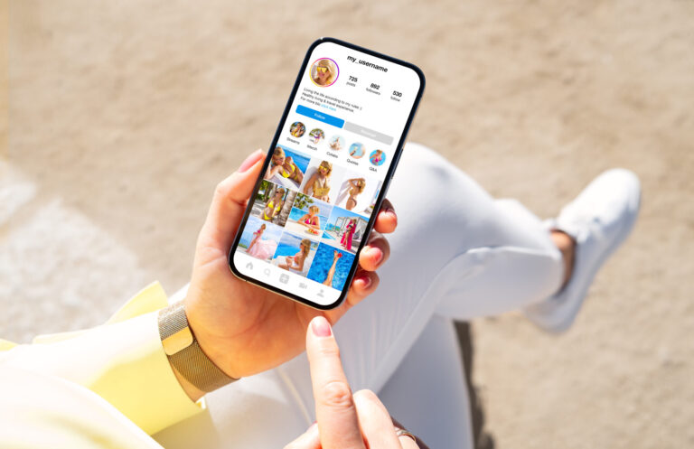 lifi media production, social media video, Woman holding phone in hand and viewing social media content