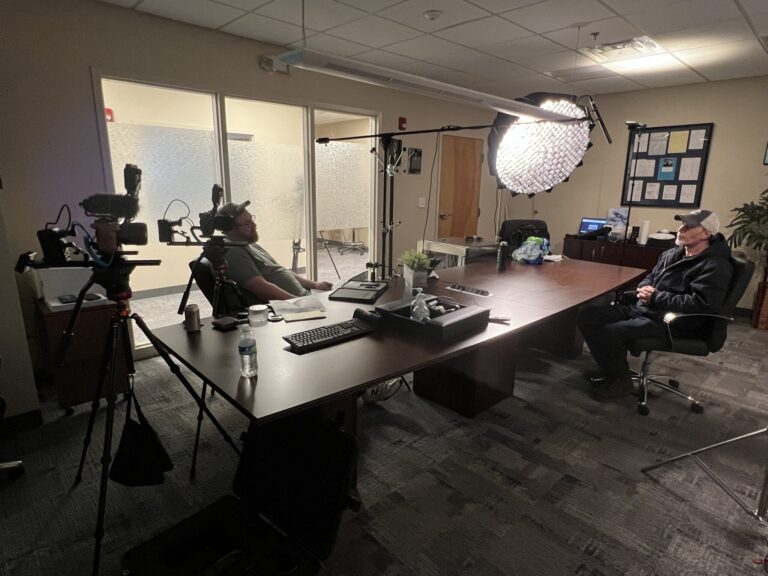 Video Production Companies Manchester, interviewer sits with interviewee before a camera