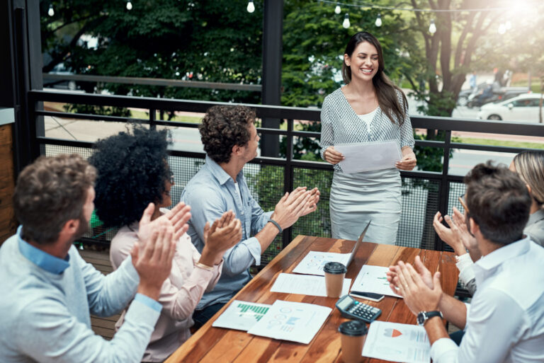 LiFi Media Production Corporate Video Trends 2025 Shot of a group of colleagues applauding during a meeting at a cafe.