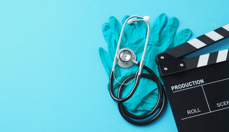 Lifi media production healthcare video production services clapperboard and latex glove and stethoscope on blue background Lifi media production new england's video production experts
