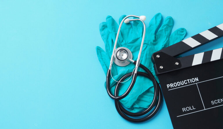 LiFi Media Production healthcare video production services, clapperboard and latex glove and Stethoscope on blue background.