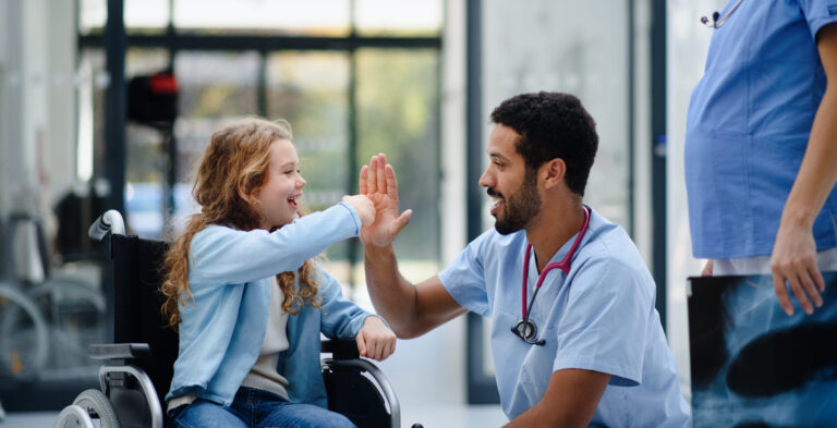 LiFi Media Production healthcare video production services, Young multiracial doctor having fun with little girl on a wheelchair.