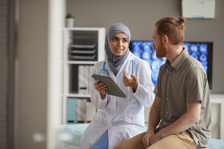 LiFi Media Production healthcare video production services, Male patient listening to his doctor while she telling about the disease using digital tablet they sitting on couch at hospital