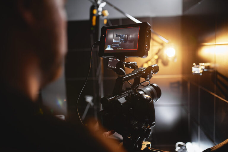 LiFi Media Production TV Commercial Production, Video production backstage. Behind the scenes of creating video content, a professional team of cameramen with a director filming commercial ads. Video content creation, video creation industry, Low key, selective focus, film graine.