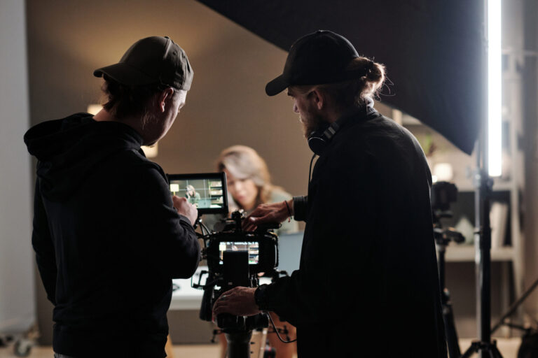 LiFi Media Production TV Commercial Production, Back view of two young men standing in front of camer aand using steadicam while shooting new commercial with female model