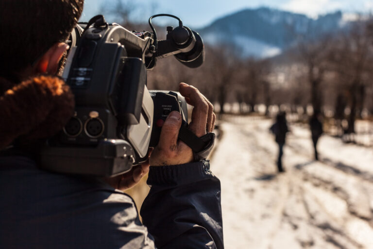LiFi Media Production Documentary Video Production, a young man using a professional camcorder outdoor