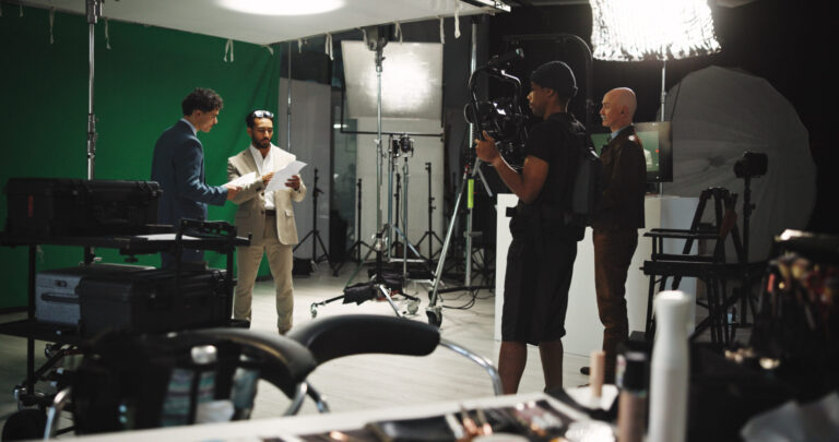 LiFi Media Production Documentary Video Production, Man, filming and stabilize with, journalist in studio of broadcast, production process and record. People, crew and cinematographer on set for shooting news, documentary footage and scene rehearsal.